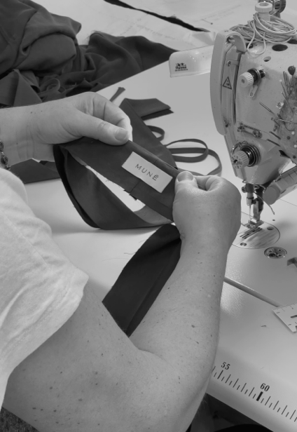 Person working with fabric and a sewing machine, with 'Mune' branding visible.