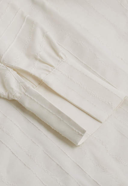 Close-up of a white fabric garment on a light background